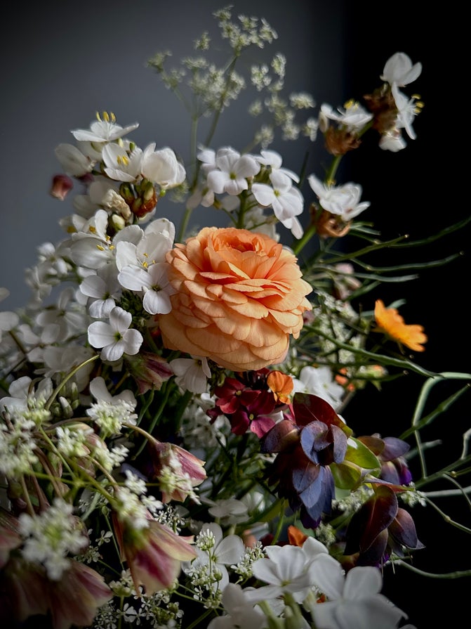 Multicoloured floral arrangement in a ceramic bowl